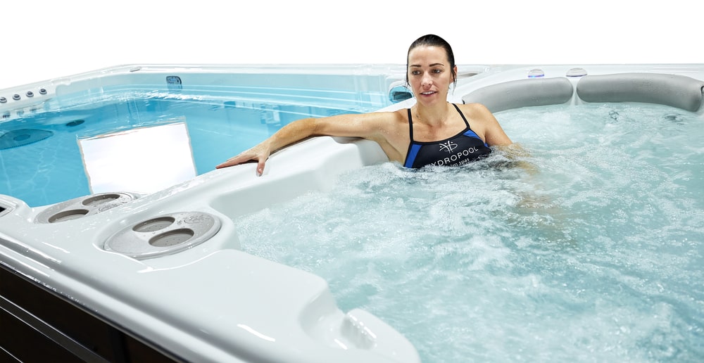 woman is enjoying hydrotherapy session in swim spa