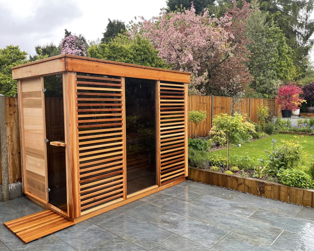 Leisurecraft outdoor sauna surrounded by greenery in patio