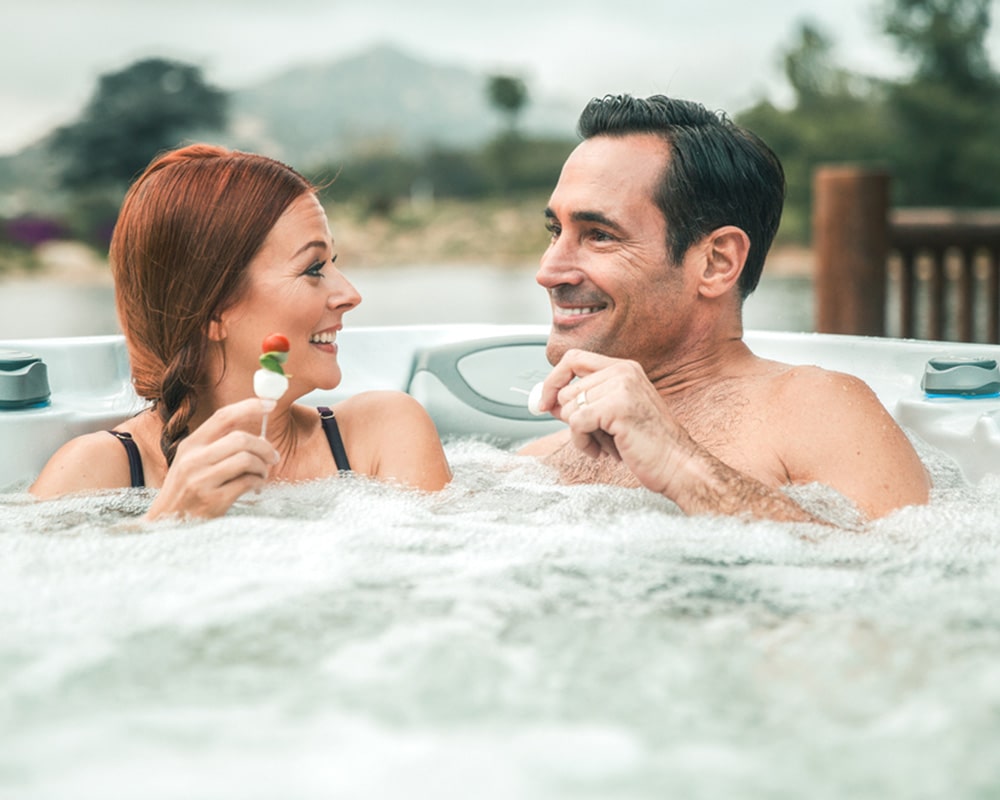 Couple snaking in hot tub