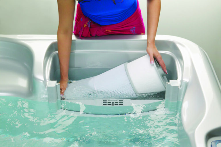 woman is replacing hot tub filter|working hot tub filter|clean water in hot tub