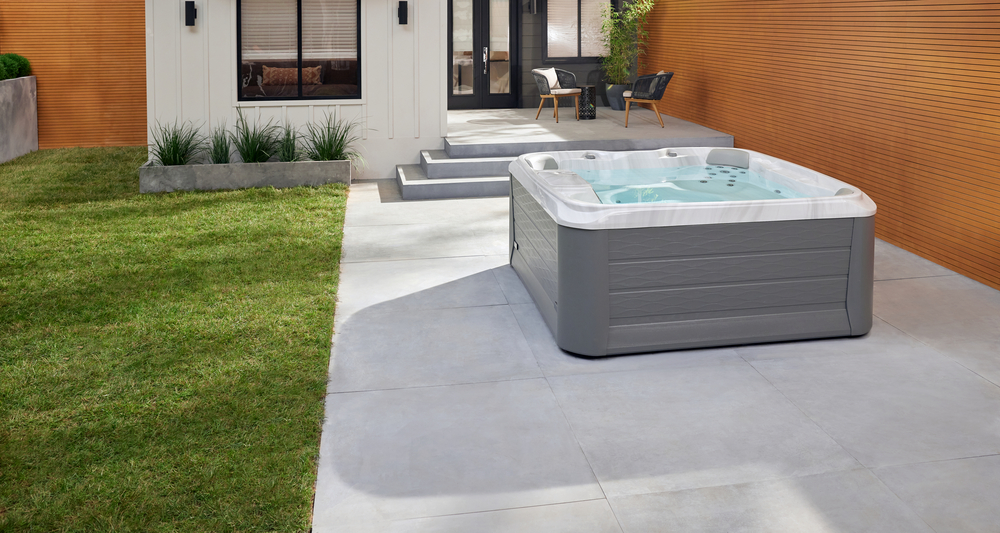 A modern backyard with a hot tub and patio