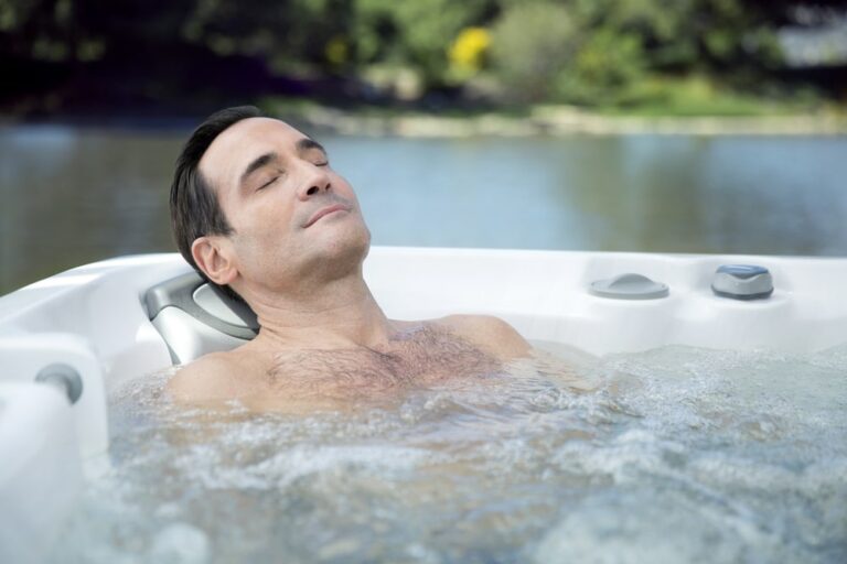 man is enjoying his time in hot tub|a couple in a hot tub|woman is relaxing in sundance hot tub