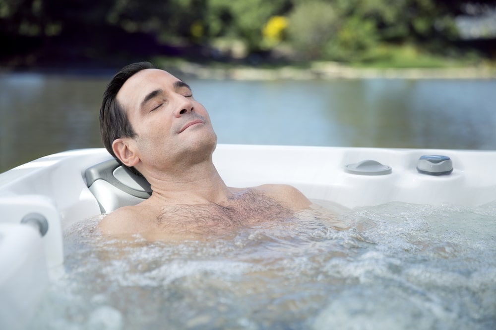 man is enjoying his time in hot tub|a couple in a hot tub|woman is relaxing in sundance hot tub