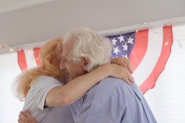 woman warmly hugs USA veteran||||