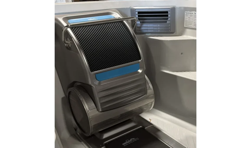 Close-up of the swim jet assembly and intake grille inside an empty swim spa shell.